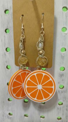 Handmade Macrame beaded earrings with 3D printed orange slice charms. Orange Drop Earrings For The Beach, Orange Drop Earrings For Beach, Orange Dangle Earrings For The Beach, Orange Dangle Earrings For Beach, Orange Adjustable Beaded Drop Earrings, Adjustable Orange Beaded Drop Earrings, Orange Dangle Resin Earrings, Orange Resin Dangle Earrings, Summer Orange Jewelry With Fruit Design