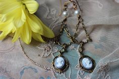 "Enchanting Blue Cameo in a lovely design called the Kathrine Necklace. Features a drop portrait cameo in a leaves embellished setting hanging from an ornate drop. Pearls and cast floral antiqued golden beads are hand linked and wire-wrapped to enhance the lovely tones and textures of this Victorian cameo. Your necklace will be finished with antiqued gold chain that is finely textured. Closure is done with our hand forged loops which are durable and allow adjustable length. You necklace has a lo Vampire Diaries Necklace, Christmas Gift Earrings, Victorian Cameo, Necklace With Pearls, Victorian Necklace, Victorian Earrings, Golden Beads, Cameo Earrings, Special Necklace