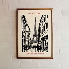 a poster hanging on the wall in front of a white brick wall with people walking down it