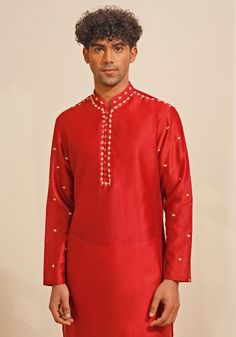 Presenting a regal Red Silk Kurta Set, featuring a Chinese collar and looped fabric buttons for a classic look. The hand-embroidered details on the neckline, shoulder, and sleeves add a touch of elegance. Paired with white pants, this ensemble is perfect for Mehendi or Sangeet events, offering a blend of traditional charm and sophisticated style. Composition : Chanderi Silk Care: Dry Clean Only and Vacuum Storage This product can be customized for sleeves, length and colour Delivery : 4-6 weeks as the product is hand crafted. Check Size Guide or choose MySize for free customisation (All Sizes above XL can be made at 15% additional cost) For more information and sizes please contact fabiliciousfashion@gmail.com or visit our Copenhagen studio. About the Designer : Shreyansh, a distinguished Fitted Straight Kurta Set With Embroidered Neckline, Traditional Sets With Embroidered Neckline For Diwali, Traditional Set With Embroidered Neckline For Diwali, Traditional Festive Sets With Embroidered Neckline, Festive Traditional Wear With Embroidered Neckline For Diwali, Elegant Festive Traditional Wear With Embroidered Neckline, Traditional Sets With Embroidered Neckline For Festivities, Festive Traditional Wear With Embroidered Neckline, Traditional Kurta With Embroidered Neckline For Diwali