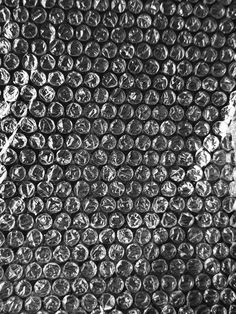 black and white photograph of glass bottle caps