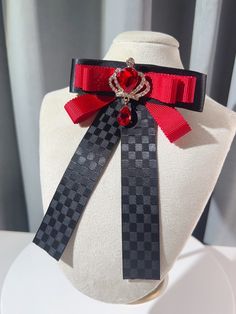 Add a touch of regal charm to your outfit with our rhinestoned crown bow tie/brooch. Available in both black and red, this versatile accessory features a dazzling rhinestone-encrusted crown design that exudes elegance and sophistication. Wear it as a bow tie or use it as a brooch to elevate your look with a hint of royal allure. Perfect for adding a touch of glamour to any outfit, this one-of-a-kind piece is sure to turn heads and make a statement. Whether you're dressing up for a special occasi Black Jewelry With Decorative Bow For Party, Black Bow Tie Jewelry For Party, Elegant Red Pins For Party, Elegant Red Party Pins, Formal Red Rhinestone Brooch, Formal Red Rhinestones Brooches, Black Bow Tie Jewelry For Formal Occasions, Black Brooch With Decorative Bow For Evening, Black Bow Tie Brooch For Wedding