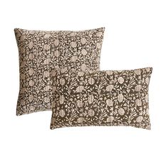 two brown and white pillows sitting next to each other