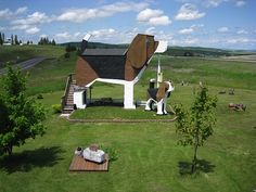 an aerial view of a dog house in the middle of a field