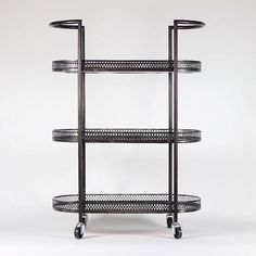 three tiered metal shelf with wheels on each side against a white background, in the shape of an oval