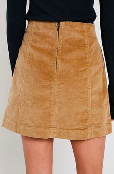 Corduroy is back in style! This mini skirt is perfect for this occasion, featuring a panel design and having a back zipper. Pair this skirt with a long sleeved top and some knee high boots for the perfect fall look. 98% cotton, 2% spandex Hand Wash Cold. imported S M L WAIST 28" 29" 30" HIP 36" 37" 38" LENGTH 16" 16.5" 17" Fall Mini Lined Skirt, Cotton Mini Skirt For Fall Workwear, Cotton Mini Skirt For Workwear In Fall, Mini Length Bottoms With Side Zipper For Fall, Corduroy Skirt For Fall Workwear, Fall Mini Bottoms With Side Zipper, Fall Corduroy Skirt For Workwear, Trendy Winter Corduroy Mini Skirt, Fall Knee-length Cotton Skirt