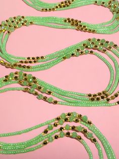 Single Strand Waist Bead, featuring delicate seafoam green glass seed beads accented with luxurious gold crystal glass beads. Why You'll Love It: Subtle Elegance: Seafoam green glass seed beads offer a soft, soothing sparkle that complements any outfit. Luxurious Accents: Gold crystal glass beads add a touch of sophistication and opulence. Perfect Fit: The adjustable single strand design ensures comfort and a secure fit for all body types. Cultural Beauty: This piece blends the rich heritage of Handmade Green Waist Beads, Gold Faceted Beads Waist Beads For The Beach, Adjustable Green Beads For Festive Occasions, Gold Beaded Chain For Summer, Gold Beaded Bracelets For Summer Parties, Bohemian Green Waist Beads With Colorful Beads, Bohemian Green Beaded Bracelets For Parties, Elegant Green Beaded Necklaces With Gold Beads, Elegant Green Beaded Bracelets For Beach