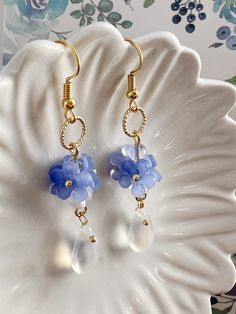 Embrace the timeless beauty of these handmade earrings adorned with delicate little blue "Forget Me Not" flowers, symbolizing love and fidelity.  Suspended from each blossom, glistening crystal drops add a touch of sparkle and allure. With their understated charm and handmade craftsmanship, they make a captivating addition to any ensemble, infusing it with grace and romance. A perfect gift for her, these earrings exude elegance, making them an exquisite choice for bridal wear or as a captivating Light Blue Crystal Earrings For Gift, Handmade Blue Dangle Flower Earrings, Blue Teardrop Flower Earrings Nickel Free, Blue Flower Earrings For Jewelry Making, Handmade Blue Teardrop Crystal Earrings, Blue Teardrop Nickel Free Flower Earrings, Blue Teardrop Nickel-free Flower Earrings, Delicate Blue Flower Earrings With Ear Wire, Handmade Blue Round Flower Earrings