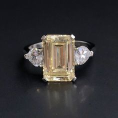 Personally Designed Yellow Citrine Art Deco ring in sterling silver. This classically designed ring is made with beautifully citrine with Emerald cut. Solid and thick band with a professional finish. You will not be disappointed with this beautiful ring.  💎 Gem Stone: Lab treated yellow citrine with emerald cut. 💎Main gemstone size: 12*8mm 💎 Side Stone: Clear Topaz 💎 Gemstone Shape: Rectangular  💎 Material: Sterling Silver with 3 times 18k white gold plating 💎 Band Size - please message us Yellow Emerald Cut Ring, Classic Yellow Citrine Birthstone Ring, Yellow Brilliant Cut Rings For Promise, Yellow Sapphire Birthstone Promise Ring, Yellow Sapphire Promise Ring Birthstone, Formal Yellow Rings With Birthstone, Formal Yellow Birthstone Rings, Classic Citrine Rings With Accent Stones, Yellow Emerald Gemstone Ring For Anniversary