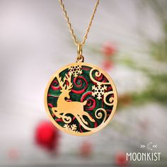 This Festive Christmas Reindeer necklace is a beautiful gift for anyone who is enchanted with the Christmas season!  This Multicolor Holiday Pendant features a Reindeer and Snowflake design that has been carefully  handmade and painted in our studio. Today, the reindeer has become an enduring symbol of Christmas. Traditionally, reindeer were considered powerful animal spirits in several Northern cultures. They were thought to symbolize wisdom, resourcefulness, and cleverness. This brightly color Handmade Round Christmas Jewelry, Handmade Round Jewelry For Christmas, Handmade Jewelry As Holiday Gift, Handmade Jewelry For Holiday Gifts, Handmade Jewelry For New Year Holiday, Green Holiday Jewelry Gift, Green Jewelry For New Year's Gift, Green Jewelry For New Year Gift, Holiday Gift Green Jewelry