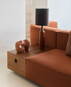 a living room with a couch, table and lamp in it's centerpiece