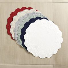 six round placemats with different colors and designs