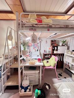 a doll house with bunk beds, desk and toys on the floor in front of it