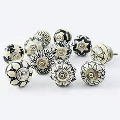 an assortment of black and white knobs with flowers on them, set against a white background