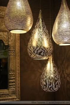 three hanging lights with intricate designs on them