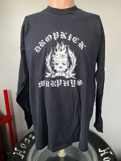 "True vintage Dropkick Murphys Fire & Brimstone longsleeve t-shirt from 1998. Size large single stitched tee in good shape, couple of tiny holes on the front. Measures 21.5\" pit to pit, 25.5\" collar to bottom." Y2k Long Sleeve T-shirt For Streetwear, Long Sleeve Band Merch T-shirt With Screen Print, Long Sleeve Cotton T-shirt With Band Merch, Long Sleeve Y2k T-shirt With Screen Print, Y2k Long Sleeve T-shirt With Screen Print, Y2k Long Sleeve Screen Print T-shirt, Band Merch Long Sleeve T-shirt For Streetwear, Long Sleeve Band Merch T-shirt For Streetwear, Black Long Sleeve T-shirt 90s Style