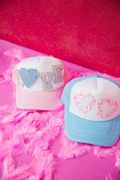 Spread some love with this unique trucker hat in pink and white. Featuring a mini glam blue "Love" letters with a cute blue denim heart patch, this hat is perfect for any casual occasion. Adjustable back allows for a comfortable and versatile fit. Love never looked so stylish! This is a made-to-order item. All customized orders are currently shipping within 14 business days. To receive item quicker, expedited shipping is available at checkout. Custom Fitted Hats Pink, Cheap Customizable Pink Hat, White Trucker Hat, Last Day To Order, Heart Patch, Heart Patches, Love Letters, Pink And White, Pink Floral