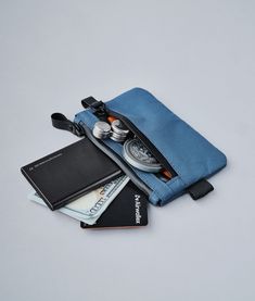 Stow your cards and cash quickly in our smallest pouch. Designed for those who want to carry as little weight as possible, the Zip Pouch has secure storage space for frequently used items such as credit cards and bank notes. With an extra pouch for coins or smaller items like your spare SIM card, you'll find room even for business cards too! Functional Rectangular Travel Accessories With Pockets, Rectangular Functional Travel Accessories With Pockets, Blue Pouch Organizer For Daily Use, Blue Pouch Organizers For Daily Use, Blue Functional Organizer, Functional Blue Organizers, Functional Blue Organizers For Everyday Use, Multifunctional Tech Accessories With Cell Phone Pocket, Practical Rectangular Travel Accessories With Pockets