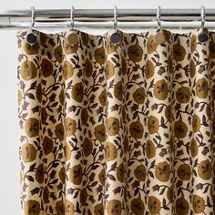 a curtain with an orange and brown flower pattern