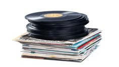 a stack of records and vinyls on top of each other