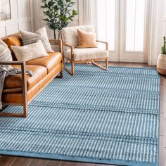 a living room with two chairs and a rug