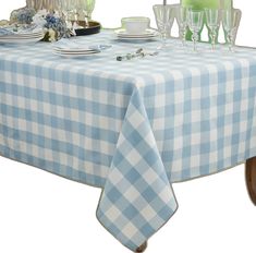 a blue and white checkered table cloth with wine glasses on it