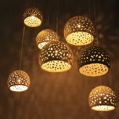 a group of lights that are hanging in the air with some sort of decoration on them