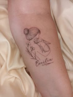 a woman's arm with a tattoo on it that reads, pelicaa