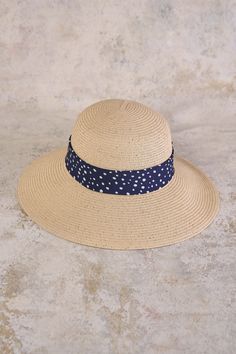 This summer accessory is fashion made easy, bringing a Parisian touch to a classic sunhat design with a polka dotted ribbon in navy and white. Perfect for your next outdoor event or beachside holiday, this sunhat with a subtle gold metallic weave, is crafted from polypropylene braid and straw in a neutral shade that will easily pair with your everyday looks. Navy Beach Hat, Spring Navy Adjustable Hats, Navy Summer Sun Hat For Vacation, Navy Brimmed Beach Hats, Navy Brimmed Hats For Beach, Navy Summer Vacation Sun Hat, Adjustable Blue Boater Hat For Summer, Navy Beach Hats For Spring, Navy Beach Hat For Spring