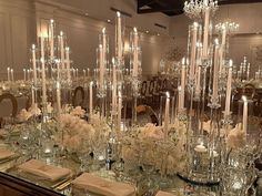 a table is set with candles, flowers and place settings for an elegant dinner party