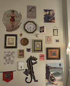 there are many pictures and clocks on the wall