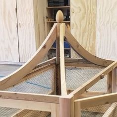 a wooden bed frame with netting around it