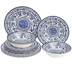 blue and white dinnerware set with floral designs on the rims, in various sizes