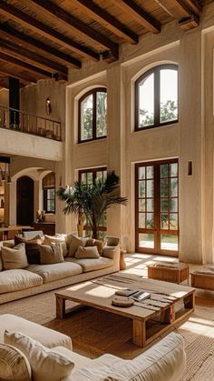 a living room filled with lots of furniture and windows