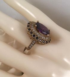 Stunning Vintage Dress Ring  With beautiful Amethysts and Sapphires  Ring size R. The inside diameter of the ring band is 1.88 cm (This is a medium ring size) The Classic Victorian setting is 2 cm long,  1.8 cm wide and sits 1 cm high  The large central stone is 1.1 cm long and 9 mm wide  and is securely claw set  All of the accent stones set all around  are all securely set and all are present, none are missing Stamped 925. Weighs 5.86 grams   A stunning Statement ring, in very good vintage con Elegant Oval Multi-stone Amethyst Ring, Elegant Lavender Rings With Halo Setting, Gold Amethyst Ring For Wedding, Fine Jewelry, Elegant Amethyst Ring With Halo Setting For Wedding, Classic Purple Sapphire Ring For Wedding, Classic Purple Sapphire Wedding Ring, Elegant Wedding Amethyst Gemstone Ring, Elegant Lavender Crystal Ring For Weddings, Elegant Lavender Crystal Wedding Ring