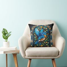 a chair with a pillow on it next to a potted plant and a blue wall