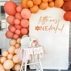 an orange and pink balloon arch with the words little miss onederfy on it