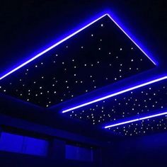 the ceiling is lit up with blue lights and some stars on it's sides