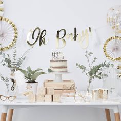 a white table topped with a cake and lots of decorations