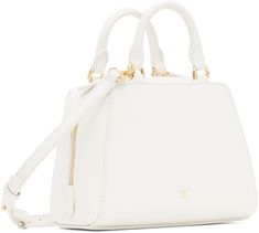 Structured and tumbled buffalo leather top handle bag in white. · Twin rolled carry handles · Adjustable and detachable crossbody strap · Logo stamp at face and back face · Two-way zip closure · Card slot at interior · Canvas lining · Logo-engraved gold-tone hardware · H5.5 x W6.5 x D3.5 Supplier color: Ivory White Bag With Gold-tone Hardware And Round Handle, White Bags With Gold-tone Hardware And Round Handle, Everyday White Satchel With Round Handle, White Satchel With Gold-tone Hardware And Top Handle, White Satchel With Detachable Strap And Round Handle, White Top Handle Satchel With Gold-tone Hardware, White Shoulder Bag With Round Adjustable Handle, Classic White Satchel With Adjustable Handle, White Shoulder Bag With Adjustable Round Handle