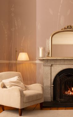 a living room with a fire place and a chair in front of the fireplace that is lit