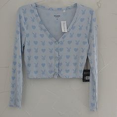 Women's Size Large. New With Tags. Playboy By Pac Sun. Front Button Up Long Sleeve Cropped Knit Top. Light Blue With Darker Blue Bunnies And Heart Print. Rayon And Spandex Blend. Lightweight. Stretches Pit To Pit Lying Flat: 17 Inches Shoulder To Hem: 18 Inches No Rips Or Stains Smoke Free Home P429 Blue Button Closure Top For Loungewear, Blue Tops With Button Closure For Loungewear, Blue Buttoned Tops For Loungewear, Spring Tops With Buttons For Loungewear, Cute Blue Button-up Top, Cute Blue Tops With Button Closure, Cropped Knit Top, Long Sleeve Cropped Top, Pacsun Tops