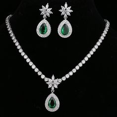 Make a stunning statement with this exquisite jewelry set, featuring a captivating emerald green cubic zircon necklace and earrings. Whether you're attending a wedding, a special event, or simply want to add a touch of sophistication to your ensemble, this set is the perfect choice. Key Features: Designed for the trend-conscious individual Elegant geometric shape and pattern Suitable for weddings and other special occasions Made of high-quality copper and adorned with shimmering cubic zirconia I Formal Green Cubic Zirconia Emerald Necklace, Green Crystal Jewelry Sets For Formal Occasions, Green Cubic Zirconia Jewelry Set With Jewels, Formal Green Jewelry Sets With Sparkling Stones, Green Cubic Zirconia Necklace With Matching Earrings, Green Cubic Zirconia Necklaces With Matching Earrings, Green Jewels Jewelry Sets For Anniversary, Green Jeweled Jewelry Sets For Anniversary, Green Sparkling Stones Jewelry Sets For Wedding