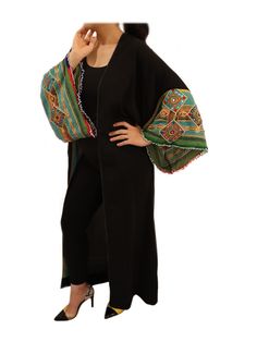 Looking for a statement piece that will take your wardrobe to the next level? Look no further than this exquisite Black and Green Embroidered Chapan Light Coat Robe. Drawing inspiration from traditional Afghani Chapan and Middle Eastern/North African robes, this piece is a true masterpiece. Featuring stunning Islamic geometric patterns and intricate embroidery, this coat robe is a feast for the eyes. The vibrant green, red, and blue colors pop against the black background, making this the perfect addition to any outfit. Whether you're dressing up for a special occasion or adding a touch of elegance to your everyday wear, this robe is sure to turn heads. So why wait? Treat yourself to the beauty and luxury of this Black and Green Embroidered Chapan Light Coat Robe today and elevate your sty Embroidered Black Kaftan For Traditional Ceremonies, Traditional Black Abaya With Floral Embroidery, Black Bohemian Embroidered Abaya, Traditional Embroidered Abaya, Bohemian Embroidered Abaya For Traditional Ceremonies, Traditional Black Festive Kimono, Traditional Multicolor Embroidered Geometric Kaftan, Traditional Black Kaftan With Floral Embroidery, Traditional Kaftan With Embroidered Sleeves For Eid