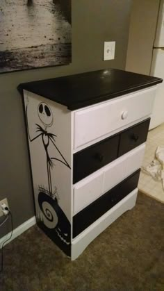 a white and black dresser with a cartoon character painted on it