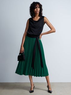 Pleated High Rise Midi Skirt | NY&Co Chic Green Flowy Pleated Skirt, Chic Asymmetrical Lined Pleated Skirt, Chic Asymmetrical Pleated Lined Skirt, Chic Green Pleated Skirt For Fall, Chic Green Midi Pleated Skirt, Chic Green Pleated Maxi Skirt, Chic Green Pleated Workwear Skirt, Chic Green Pleated Skirt For Work, Chic Green Lined Pleated Skirt