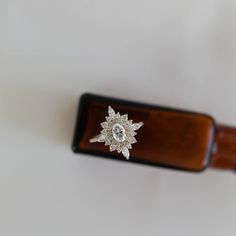 a close up of a wooden object with a diamond brooch on it's back