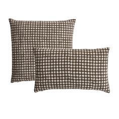 two black and white houndskin pillow covers on top of each other, one in the middle