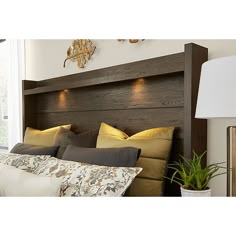 the headboard is made from wood and has two lights on each side of it