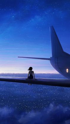 a woman sitting on the edge of an airplane looking out at the sky and stars